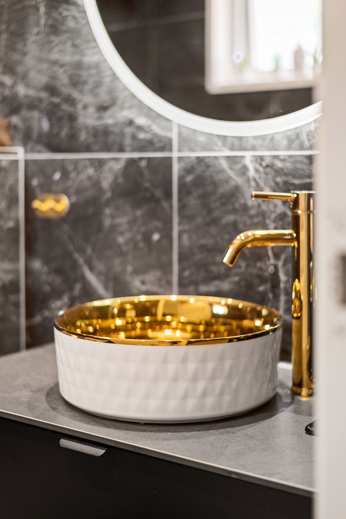 services-02 Luxury bathroom interior with a golden sink and modern faucet, offering an elegant and sophisticated design.